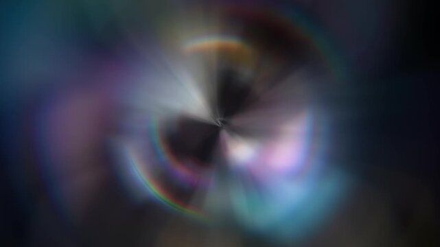 Animated prismatic rainbow ring portal with chromatic aberration glow and iridescent light on dark blurred background. Holographic circle motion overlay for cinematic title, transition, and creative