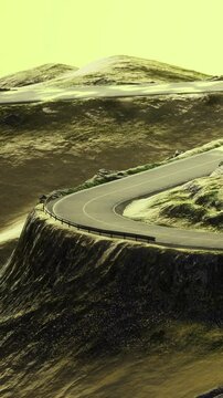 A winding road travels along a hill. The landscape includes grassy patches and rocks. The sky shows a bright hue as the sun sets on the horizon.