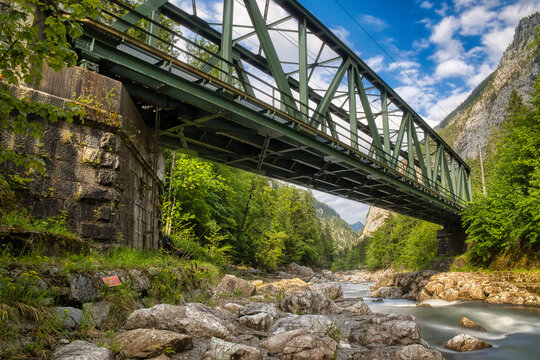 Steel railway bridge over mountain river canyon