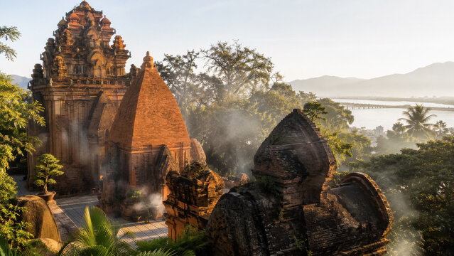 Ancient brick Cham temple with stone statue in misty tropical morning .generative AI