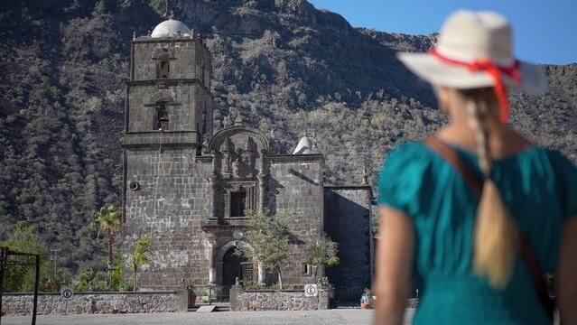 A senior woman enjoys her exploration of San Javier Mission near Loreto as she takes in the beauty of sunrise in Baja California Sur