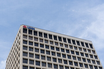 Naklejka premium Toronto, Ontario, Canada - June 2, 2026: UHN logo on top of the Princess Margaret Cancer Centre building on University Avenue in Toronto, Ontario, Canada. UHN is recognized as the Canadian