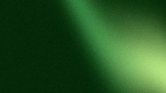 Emerald green textured background surface reflecting soft diagonal light beam in dark cinematic studio with film grain aesthetic
