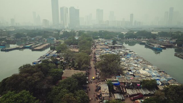 Aerial view of Sewri village near the Dockyard area in Mumbai, India, capturing a striking contrast between traditional coastal settlements and industrial port infrastructure.
