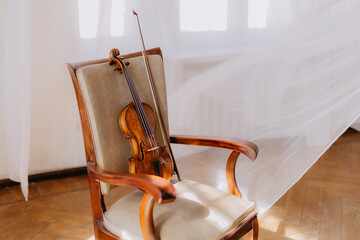violin and wooden chair © Liliana