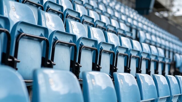 Rows of Empty Light Blue Plastic Seats in a Sports Stadium, Close Up Diagonal Perspective of Vacant Bleachers