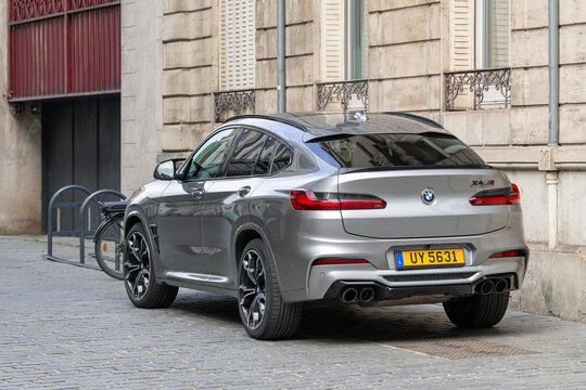 Nancy, France - May 11th 2026 : View on a grey BMW X4 M Competition parked on a street along a building.