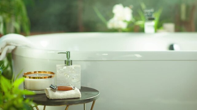Tranquil bathroom with white bathtub, lush greenery & white flowers. A small table holds a candle, soap dispenser, razor, & towel, creating a luxurious home spa experience for self-care & hygiene.