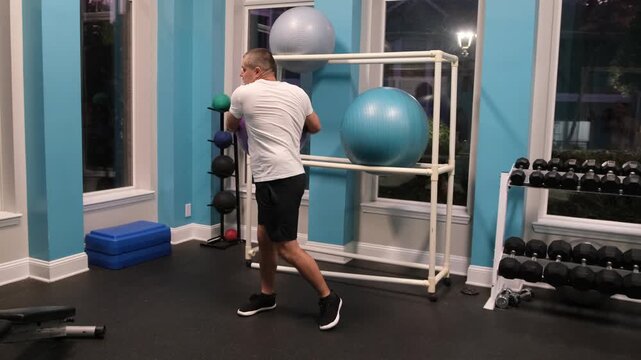 Athletic man exercising with stability ball
