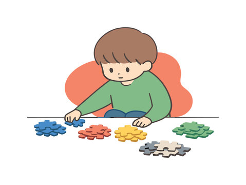 Quiet child sorts puzzle pieces on a low table, grouping colors and edges