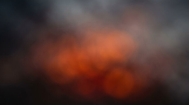 Abstract warm light leaks and dark glowing ashes blending into a textured background