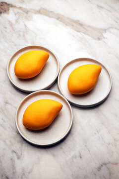 Mango mousse dessert on a ceramic plate