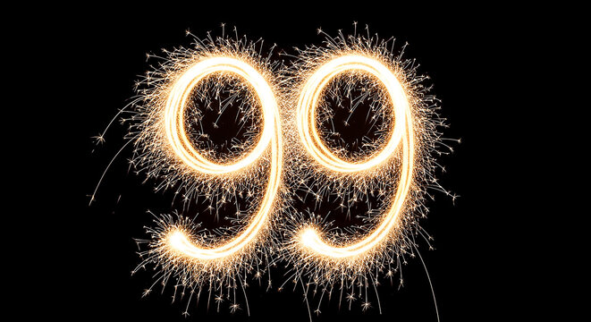 Dazzling firework sparks create the number 99, symbolizing celebration, milestone, or anniversary with bright golden light against a dark backdrop.
