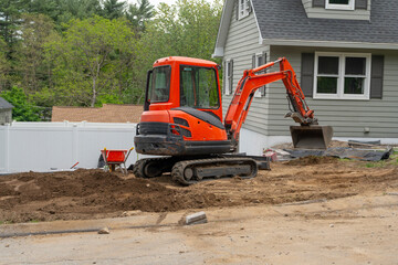 excavator in front yard of residential building © nd700