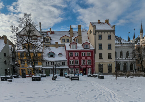 January 21, 2022, Riga, Latvia Snowy Panorama of Livu Square in Old Town Riga with Tanqueray Gin Advertising Displays