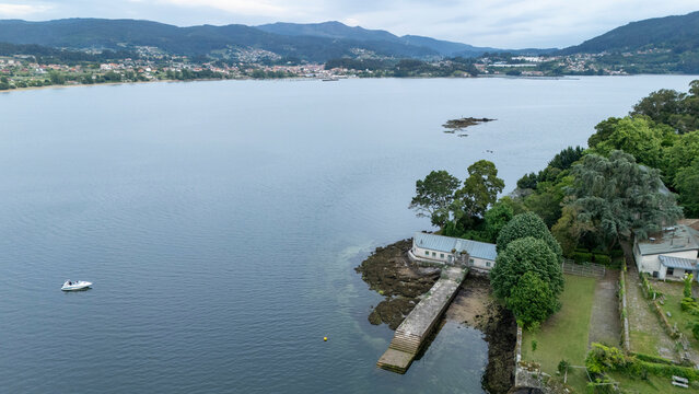 San simon island and jetty with boat in r&iacute;a de vigo