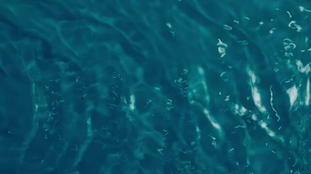Tranquil deep teal water ripples creating a soothing and mesmerizing abstract liquid background