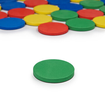 High-quality product photography of vibrant circle counting discs in organized rows. Premium studio shot of multicolored flexible plastic educational supply for commercial catalog.