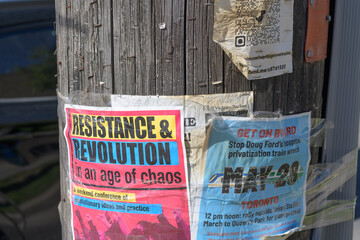 Naklejka premium street posters stapled to a wood pole in Toronto (protest)