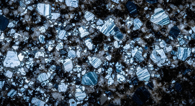 Microscopic view of mineral crystals in geological thin section rock sample with microscopic