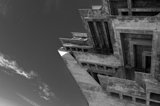 Low-Angle Black and White View of Brutalist Concrete Building Facade