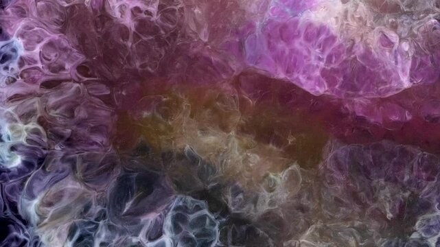 Abstract display of alcohol ink in vibrant colors captured in a video art format