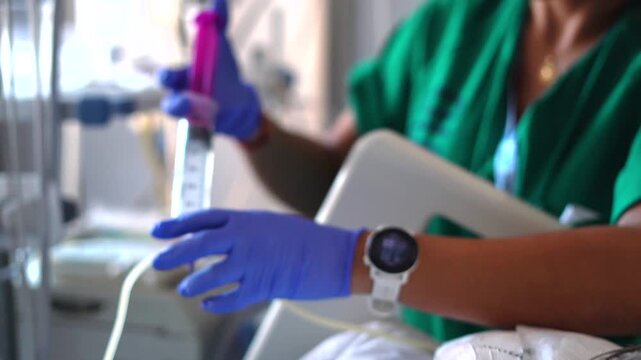 Nurse administering medicine through nasogastric feeding tube
