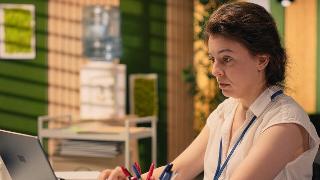 Overworked woman showing signs of chronic exhaustion and burnout, being ineffective and drained due to high responsibility, Weary female with fatigue sitting at desk in modern corporate office.