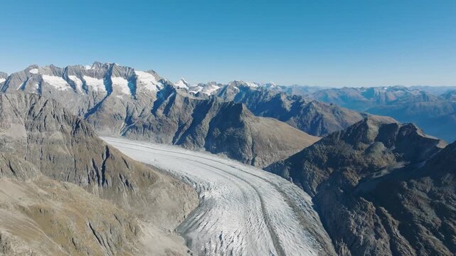Aerial drone view of Aletsch Glacier in Switzerland. Frozen ice texture, crevasses, and alpine nature landscape from above. Melting glaciers. Global warming.