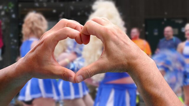 mass march LGBTQ community, Gay pride parade in city with rainbow flags, demonstration people, mass march lesbian, gay, bisexual, minority festival, male hands close up gesture heart