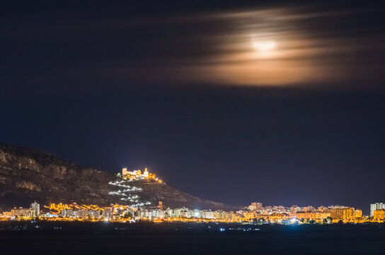 Majestic Moon Shining Over Cullera Fortress and Lit Up Town | Valencia