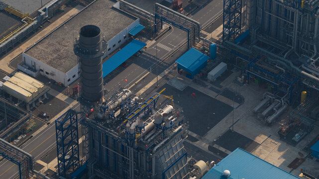 Aerial view of Sriracha Power Plant GSRC with industrial infrastructure, a tall chimney stack, and complex piping systems Tambon Khao Khan Song, Chang Wat Chon Buri, Thailand.