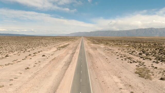 Endless desert highway stretching toward distant mountains symbolizing freedom adventure and limitless possibilities.