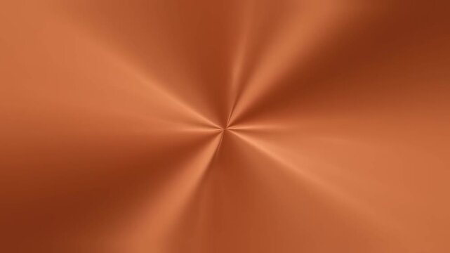 Slow rotation close up of brushed copper metal surface with radial sheen in studio macro product shot