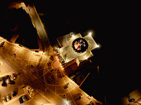 Aerial view of the illuminated Knisja Parrokkjali ta' Munxar and its surrounding square at night Il-Munxar, Regjun Ghawdex, Malta.