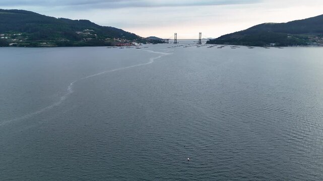 Aerial view flying over ria de vigo towards rande bridge