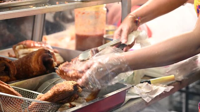 Thai street vendor preparing authentic local snacks at a bustling night market stall in Thailand; chef cooking delicious Asian street food with vibrant night lights and lively atmosphere.