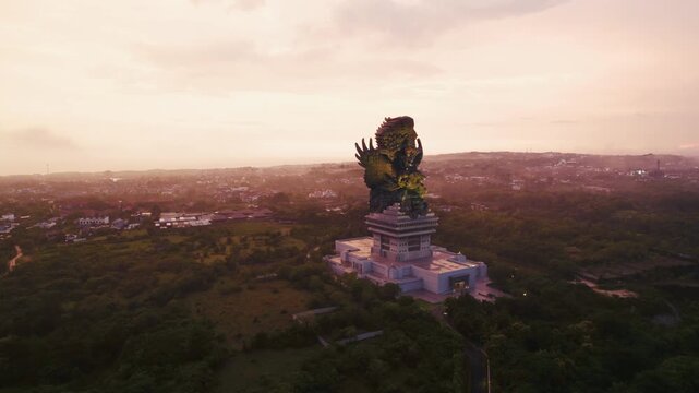 Aerial view of Garuda Wisnu Kencana statue at sunset