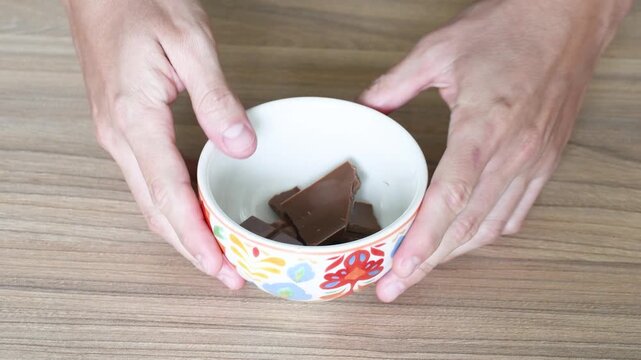 Man crushing a chocolate bar with his hands