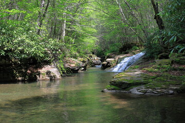 Water cascades down a picturesque waterfall where remote rivers join in a stunning location © John