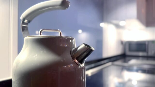 kettle boiling with steam emerging from spout with modern kitchen background