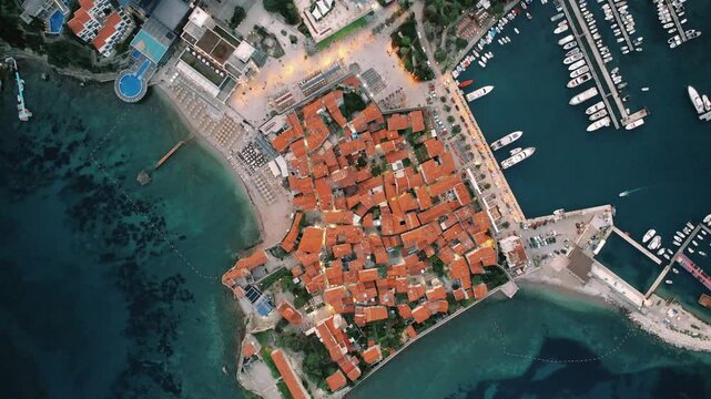 Harbor view panorama. Highresolution aerial capture showcasing terracotta rooftops and lively marina activity in Budva