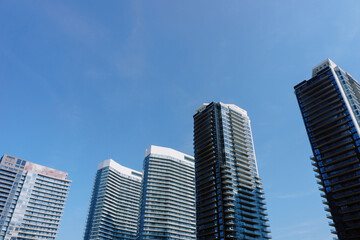 Modern high rise residential towers against blue sky © VolodymyrNadtochii