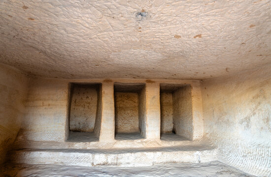 Detailed interior view of carved burial niches inside an ancient sandstone tomb at the Hegra archaeological site in AlUla Saudi Arabia.