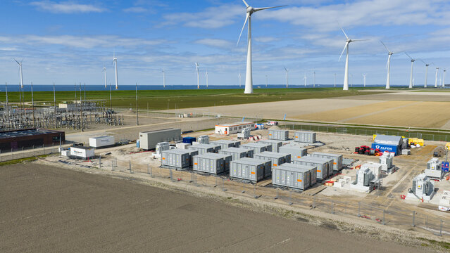 Espel, Netherlands - 04 April 2026: Aerial drone view of a large battery park near Windpark Noordoostpolder, showing renewable energy storage, grid balancing, containers and transformers.