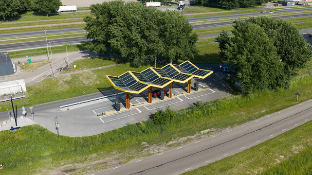 Darp, Netherlands - 23 May 2026: Aerial drone view of a Fastned fast charging station along the highway, showing DC EV charging, electric mobility, clean transport and highway infrastructure.
