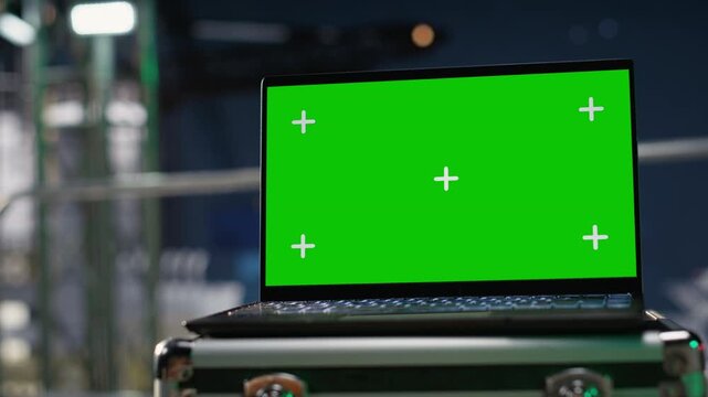 Green screen mockup laptop on drilling barge deck tracks fuel shortages during oil crisis with green screen laptop mockup.