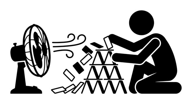 Man building Jenga game tower blown by fan.