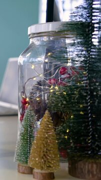 Vertical video: Cam panning at office desk showing gifts, jar lit, brush tree for cheer, copy space