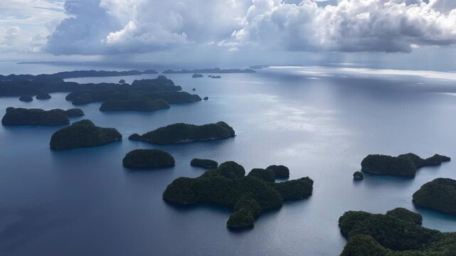 Low clouds drift over Palau's scenic Rock Islands. This tiny and beautiful island-nation is a popular destination for divers, snorkelers, kayakers, and World War II buffs. 